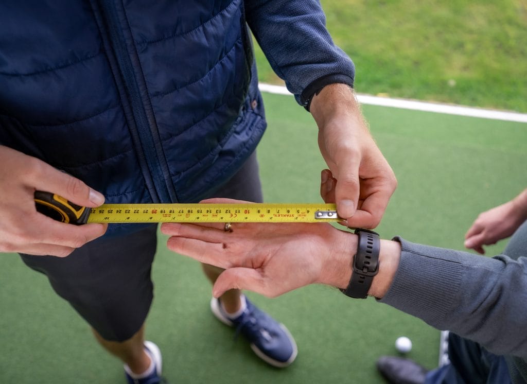 golfer getting hand measured during golf lesson in bristol