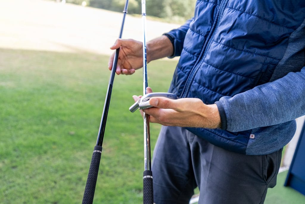 golf coach in bristol comparing golf shafts during lesson