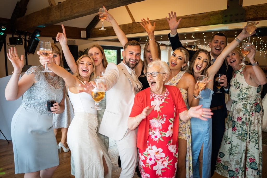 Family dancing joyfully at a wedding reception at Thornbury Golf and Lodge, a charming wedding venue near Bristol perfect for unforgettable weddings.
