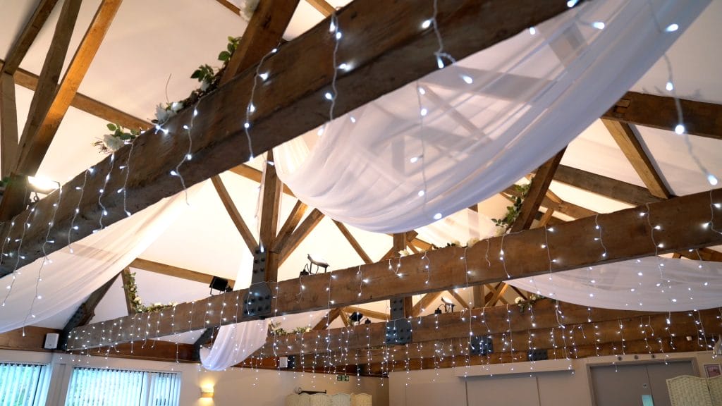 function space decorated with white draping and fairy lights at wake venue in bristol