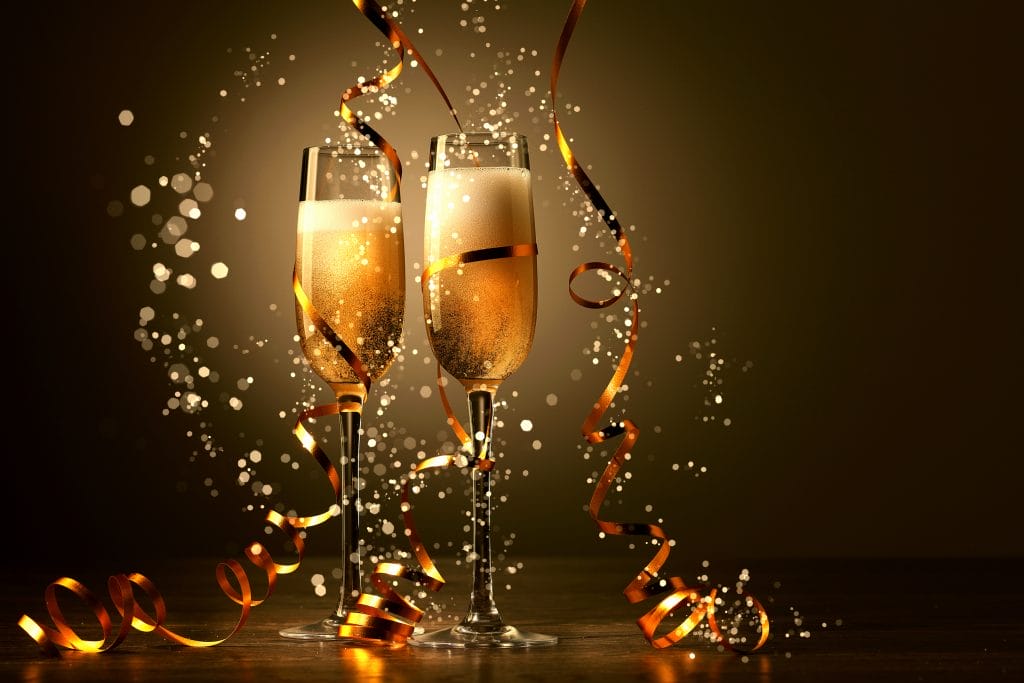two champagne glasses coverved in gold and sparkles for new years eve in bristol