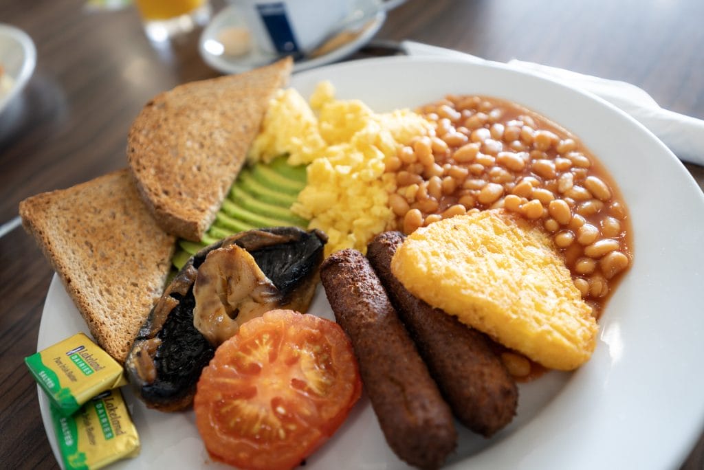 Traditional full English breakfast plate being served at a welcoming cafe in Bristol, known for great food and breakfast options