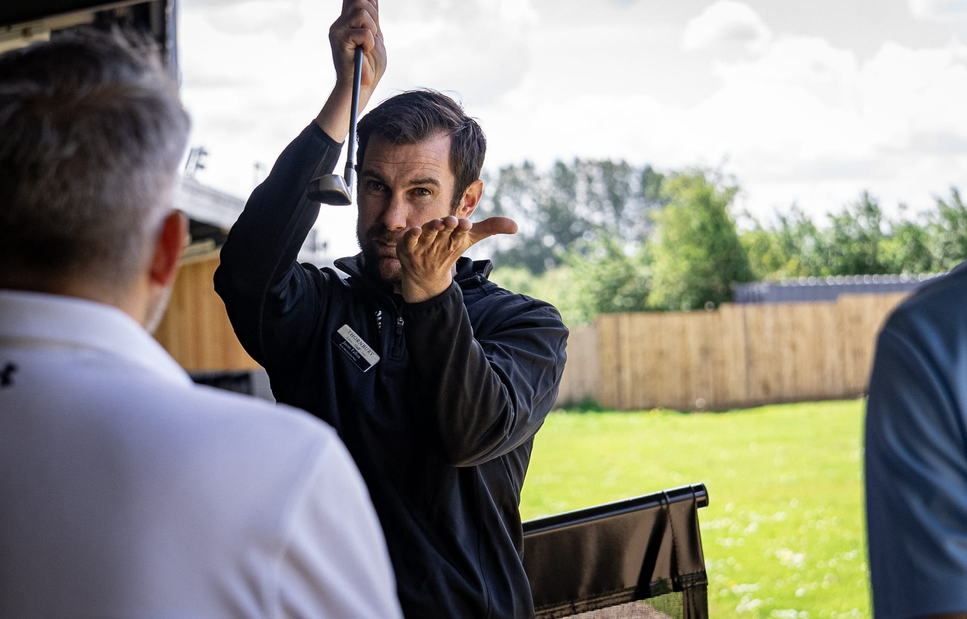golf pro delivering a golf lesson in bristol explaining club loft
