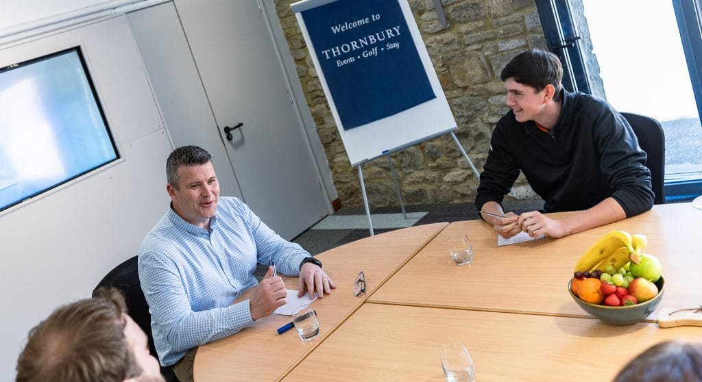 company staff laughing and talking at a conference venue in bristol