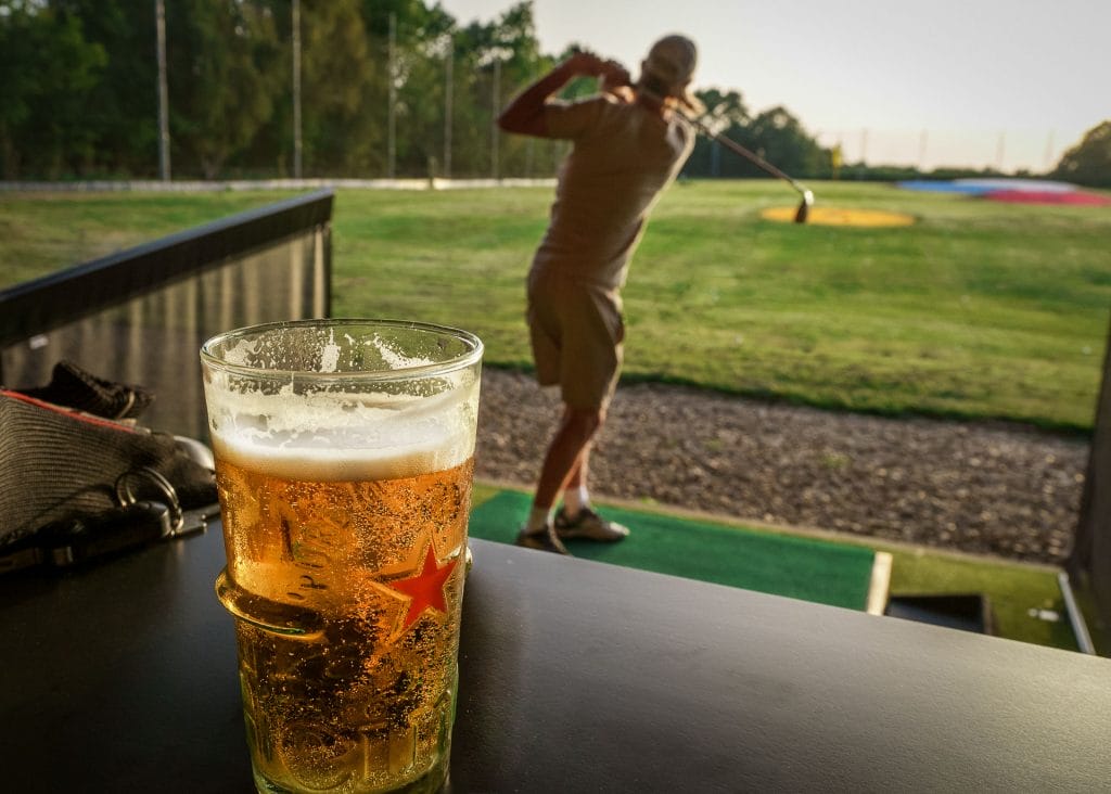 cold beer overlooking golfer at driving range near bristol