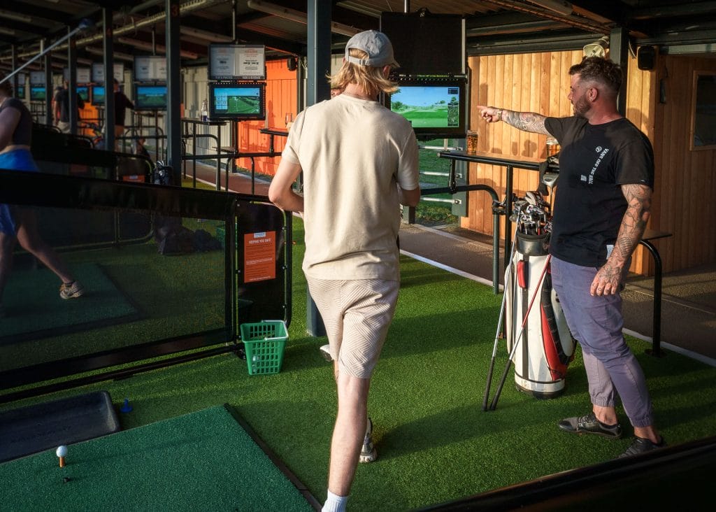 golfers smiling at driving range in bristol