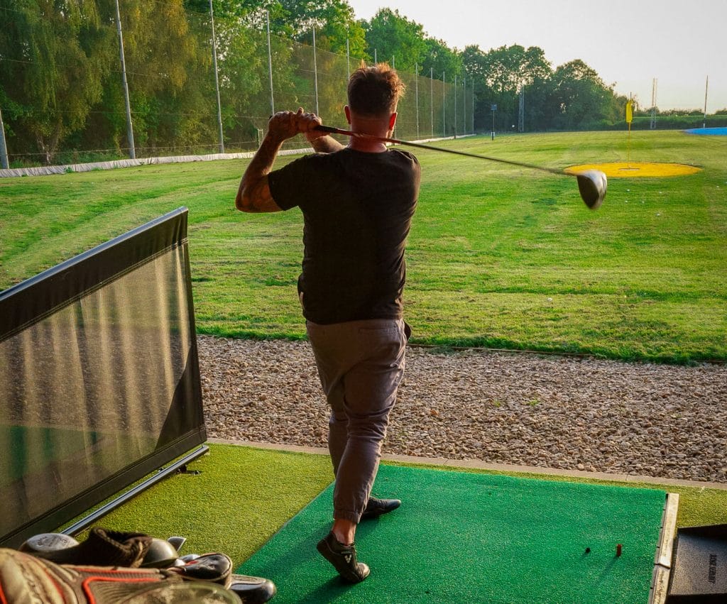 man hitting out of trackman driving range in bristol