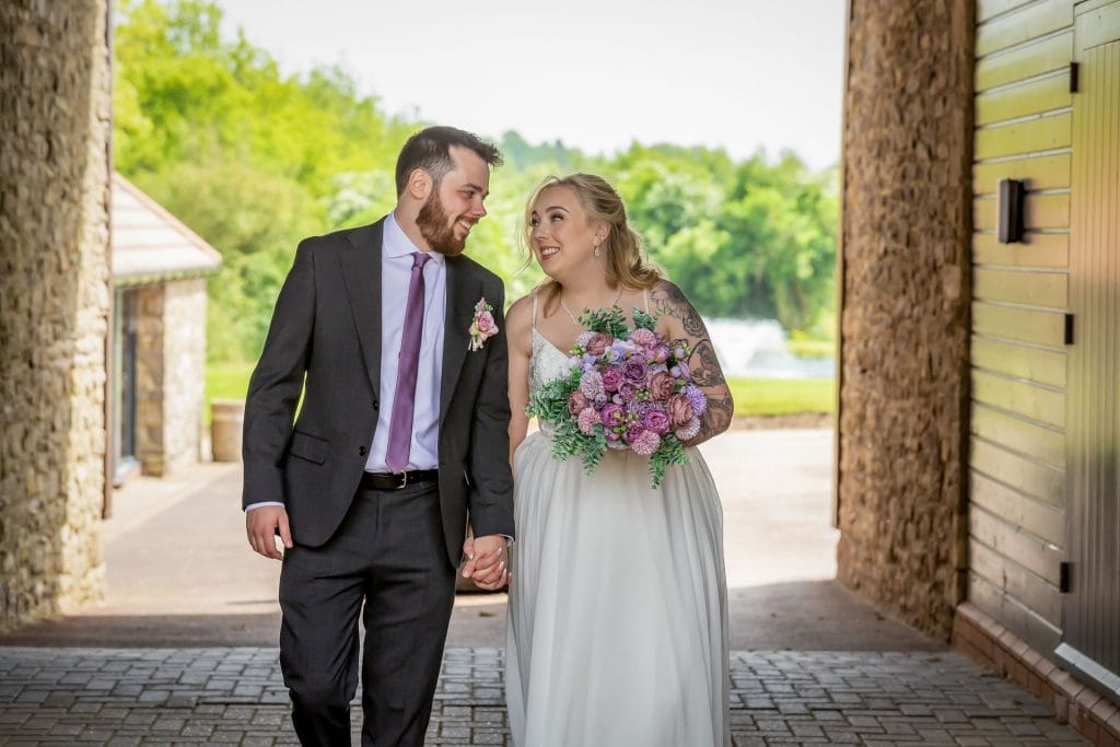 newly married couple smiling at each other at wedding venue near bristol