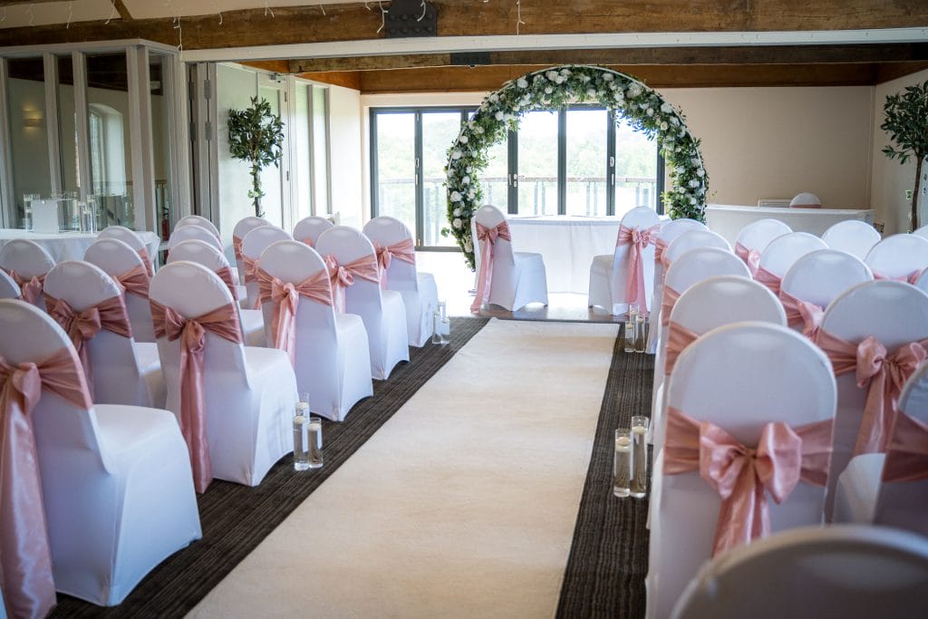 Beautiful wedding near the cotswolds with the aisle setup at Thornbury Golf and Lodge, a stunning outdoor ceremony space