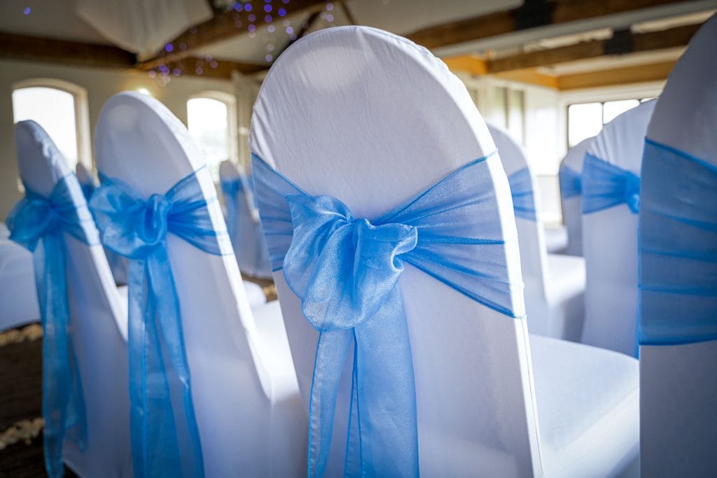 Wedding chair decorated with blue ribbon at Thornbury Golf and Lodge, a stylish wedding venue near Bristol