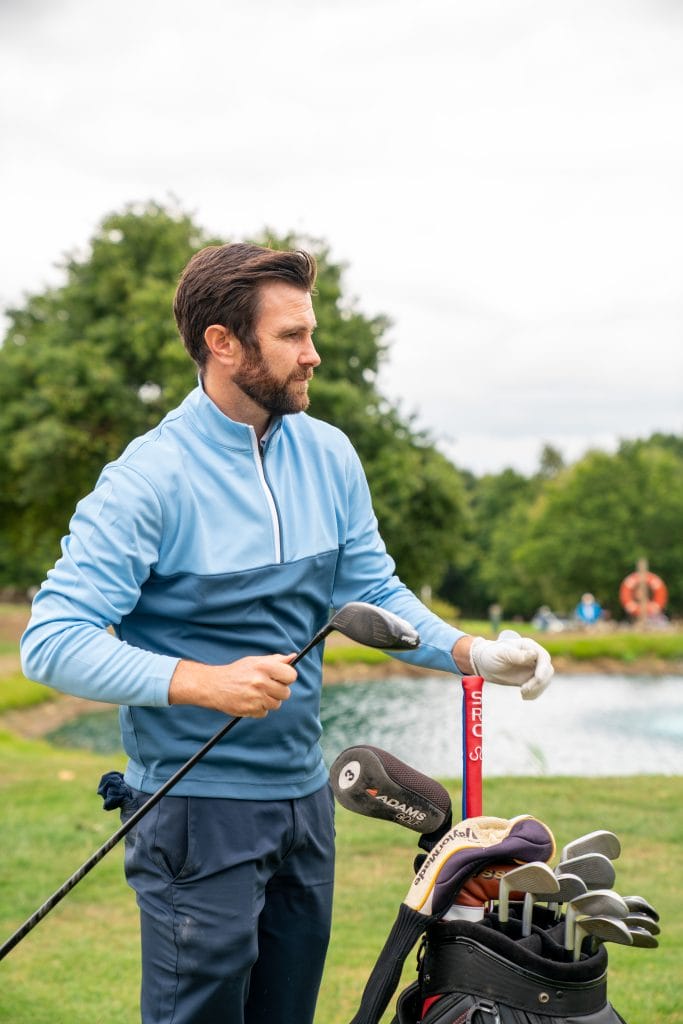 man getting out golf club stood infront of water fountain at golf club in bristol