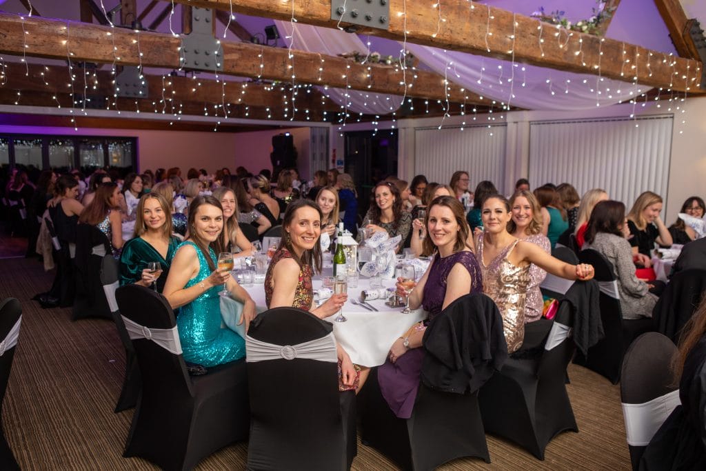 busy room with christmas decorations during a christmas party in bristol