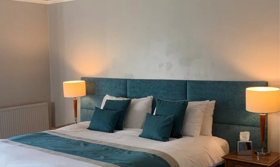 freshly made bed with table lights at hotel near bristol