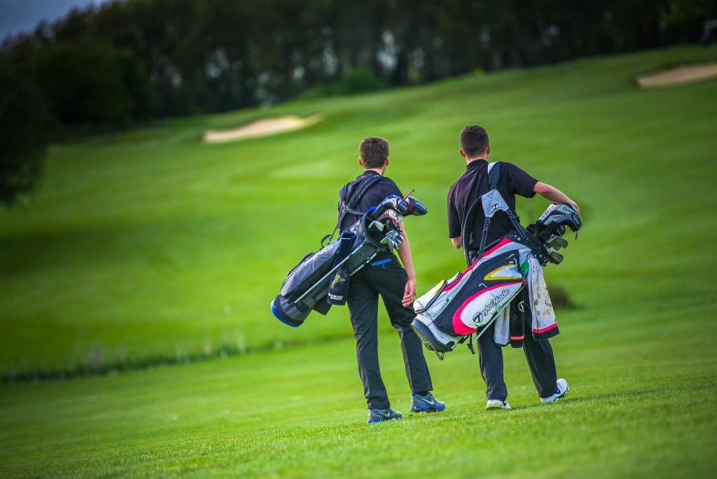 two young men playing 9 hole golf course in bristol