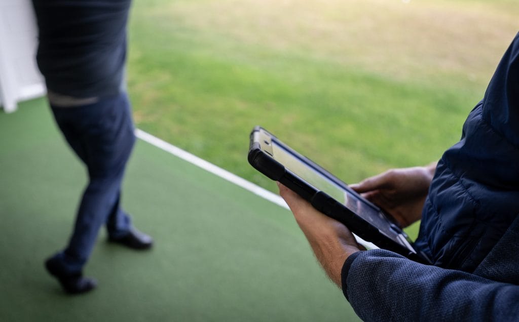 golf teacher in bristol analysisng players swing with ipad