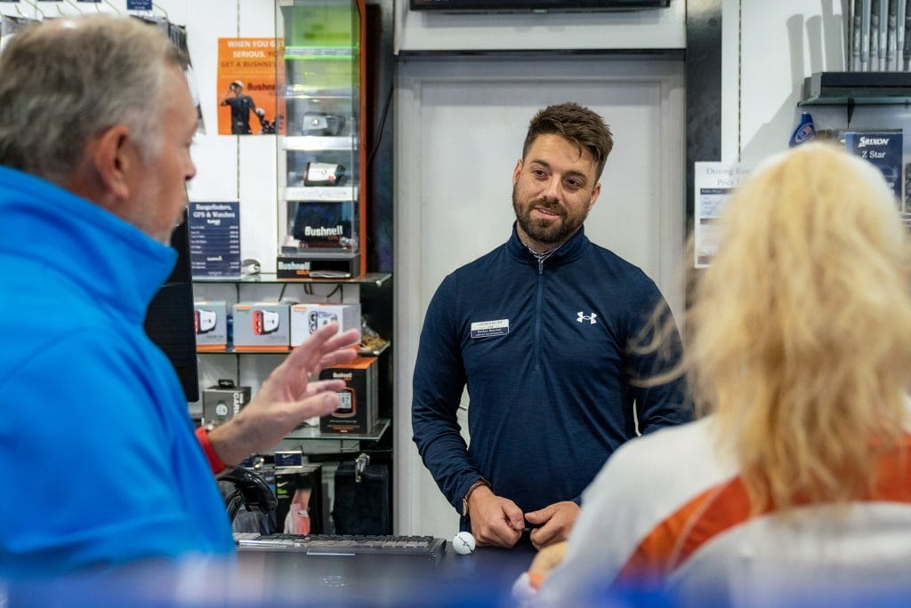two players talking with golf pro near bristol