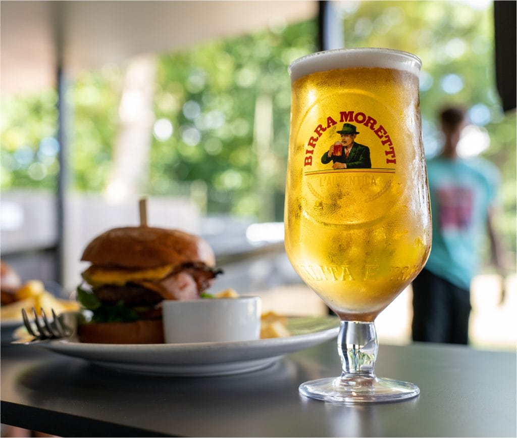 cold pint of moretti and burger at bar in bristol