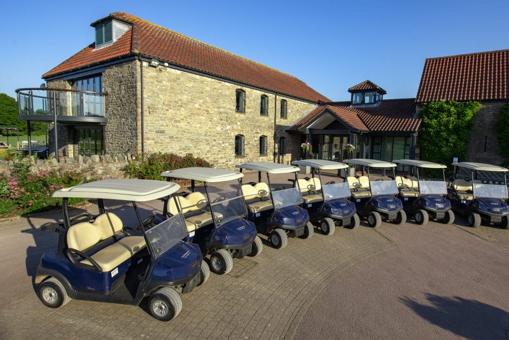 fleet of golf buggys outside golf club house in bristol